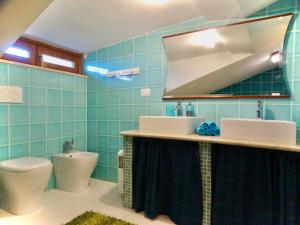 a bathroom with a toilet and a sink and a mirror at Villa Bel Lago in Bracciano +75 photos