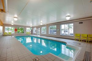 a large swimming pool in a large room with windows at Best Western Milton in Milton