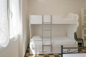 a white bunk bed in a room with a window at Casa Casui in Ventimiglia