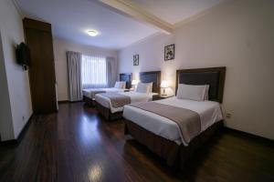 Postel nebo postele na pokoji v ubytování Hotel Calacoto + 37 fotografií