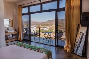 a bedroom with a bed and a large window with a view at Starlight bungalow queen 4 in El Porvenir