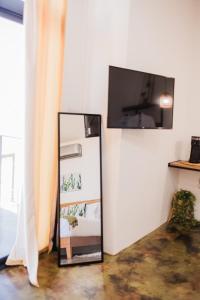 a refridgerator with a tv on a white wall at Starlight bungalow queen 4 in El Porvenir