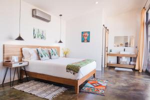 a bedroom with a large bed and a table at Starlight bungalow queen 4 in El Porvenir