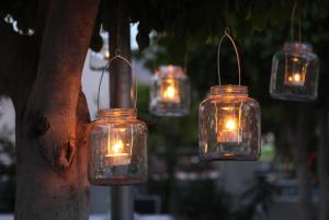 a group ofason jar lights hanging from a tree at Santuario San José in San José