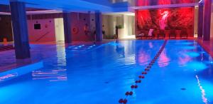 a swimming pool with blue lights in a building at APARTAMENT w PLATINUM MOUNTAIN in Szklarska Poręba