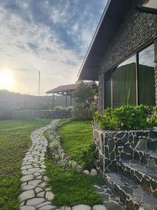 a stone path next to a house with a building at Pika Cabins 1 in San Carlos