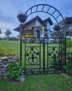 a black gate with a house behind it at Pika Cabins 1 in San Carlos