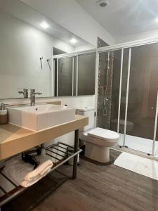 a bathroom with a sink and a toilet and a shower at BHB Hotel Boutique in Santiago