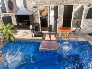a swimming pool in front of a house at Villa Paradise Playa Del Carmen in Playa del Carmen