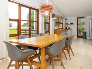 comedor con mesa de madera y sillas en 8 person holiday home in Knebel, en Knebel