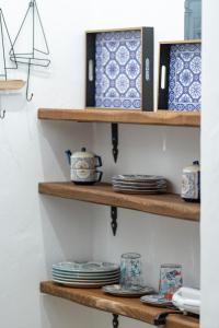 a shelf with blue and white plates on it at Galazio Seaside Luxury Rooms & Coffee Shop in Platamonas
