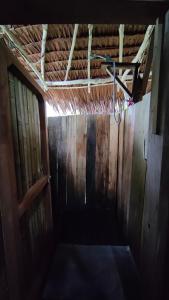 a dark room with a door and a hanger at Serenity Treehouse in Port Olry