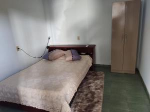 a bedroom with a bed with two pillows on it at Quarto aconchegante na terra das cataratas in Foz do Iguaçu