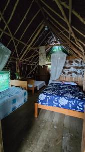 a bedroom with two beds in a room at Serenity Treehouse in Port Olry