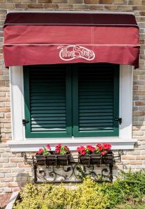 a window with flowers in boxes on a building at The Step Family Hotel in Sunny Beach