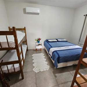 a bedroom with a bed and a bunk bed at Vila Axé Flat Lua in Prado +30 photos