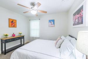 a bedroom with a bed and a ceiling fan at Hidden Gem in San Antonio