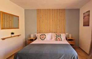 a bedroom with a bed with two pillows on it at Casa Cotillo 13 next to Los Lagos Beach Highspeed Wifi in Cotillo