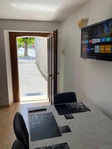 a room with a table with a laptop on it at TreeStay - Ampio appartamento moderno completo di tutto 