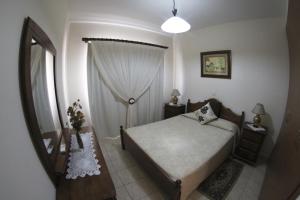 a small bedroom with a bed and a window at Eve Pissouri Xιnisteri Villa in Pissouri
