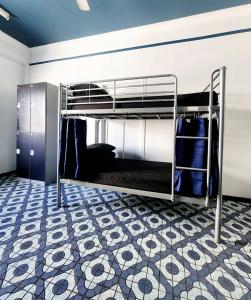 a room with bunk beds with a tiled floor at Wanna Stay? in Cairns