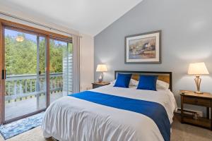 a bedroom with a large bed and a large window at Stone Ridge Baileys Harbor in Baileys Harbor