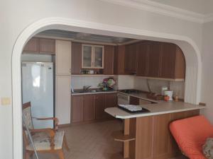 a kitchen with wooden cabinets and a white refrigerator at Yalova star in Çınarcık