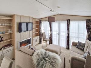 a living room with a couch and a fireplace at 6 person holiday home in Tansøy-By Traum in Tansøy