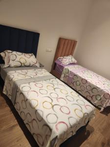 Postel nebo postele na pokoji v ubytování Gardénia la perle de Martil