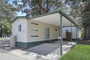 a small yellow and white house with a canopy at Reflections Coffs Harbour - Holiday Park in Coffs Harbour