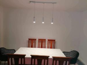 a dining room with a white table and chairs at DOM 4 SEZONY in Osłonin +18 photos