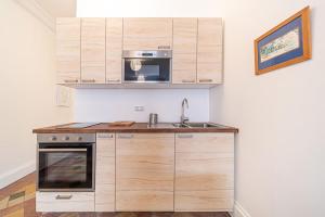 a kitchen with a sink and a microwave at Le petit Aguesseau-piscine du Rhône Bellecour in Lyon
