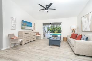 a living room with a couch and a ceiling fan at Beautiful Spacious Home! Close to Beaches - HEATED Private Pool in Englewood