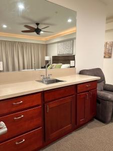 a kitchen with a sink and a living room at Hotel Coral Reef in Kapaa