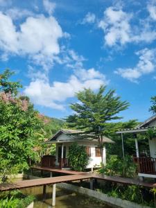 a house with a bridge over a body of water at Nakhokyor Farm in Ko Yao Yai