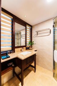 Tran Vien Dong Hotel في نها ترانغ: حمام مع حوض ومرآة