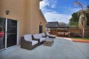 a patio with two chairs and a table at Heated Pool Pet Friendly Home in Jacksonville Beach