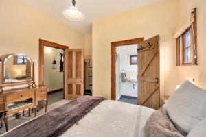 a bedroom with a bed and a vanity and a mirror at Mountain Heights Lodge in National Park