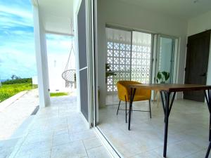 a dining room with a table and a view of the ocean at abundance okinawa in Kouri