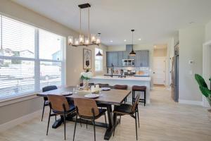 a dining room and kitchen with a table and chairs at Amongst The Waves in Ocean Shores