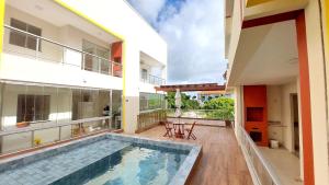 a large house with a swimming pool in the backyard at Salt Beach Residence Inn in Salinópolis