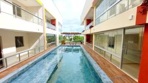 a swimming pool in the middle of a building at Salt Beach Atalaia Residence Inn in Salinópolis