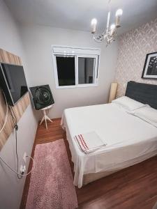 a small bedroom with a bed and a television at Allianz Parque , Perdizes in Sao Paulo