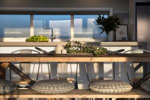 a kitchen with a table with chairs and a sink at Quartz Retreat in Daylesford