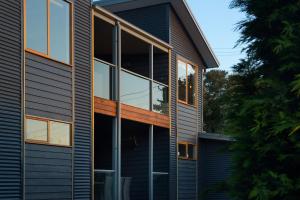 a house with large windows on the side of it at Quartz Retreat in Daylesford
