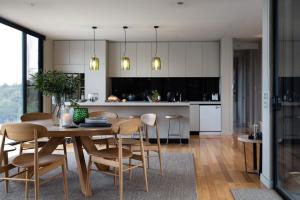 a kitchen and dining room with a table and chairs at Ridge House in Hepburn Springs