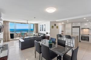 a living room and dining room with a view of the ocean at Newport Mooloolaba Apartments in Mooloolaba