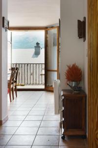 a hallway with a door open to a view of the water at Paso del Onso in Escarrilla