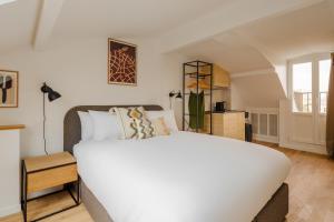 a bedroom with a large white bed in a room at Sonder Quintinie in Paris