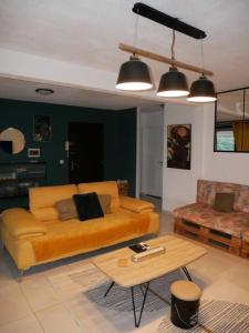 a living room with a couch and a table at Chez Steph chaleureux & cosy T3 in Fort-de-France